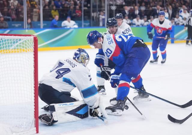 (260222) -- MILAN, Feb. 22, 2026 (Xinhua) -- Juraj Slafkovsky (front R) of Slovakia shoots during the ice hockey men's bronze medal game between Slovakia and Finland at the Milan-Cortina 2026 Olympic Winter Games in Milan, Italy, Feb. 21, 2026. (Xinhua/Tao Xiyi)