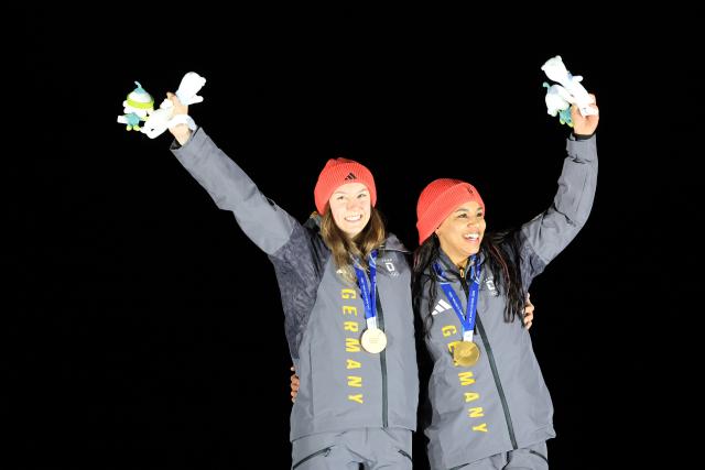 (260222) -- CORTINA D'AMPEZZO, Feb. 22, 2026 (Xinhua) -- Gold medalists Laura Nolte (L)/Deborah Levi of Germany celebrate during the awarding ceremony for the Bobsleigh 2-woman at the 2026 Milan-Cortina Winter Olympics in Cortina, Italy, Feb. 21, 2026. (Xinhua/Ding Xu)