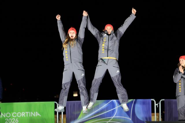(260222) -- CORTINA D'AMPEZZO, Feb. 22, 2026 (Xinhua) -- Silver medalists Lisa Buckwitz (L)/Neele Schuten of Germany jump on the podium during the awarding ceremony for the Bobsleigh 2-woman at the 2026 Milan-Cortina Winter Olympics in Cortina, Italy, Feb. 21, 2026. (Xinhua/Ding Xu)