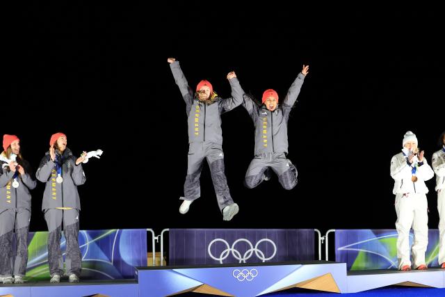 (260222) -- CORTINA D'AMPEZZO, Feb. 22, 2026 (Xinhua) -- Gold medalists Laura Nolte (3rd L)/Deborah Levi (2nd R) of Germany jump on the podium during the awarding ceremony for the Bobsleigh 2-woman at the 2026 Milan-Cortina Winter Olympics in Cortina, Italy, Feb. 21, 2026. (Xinhua/Ding Xu)