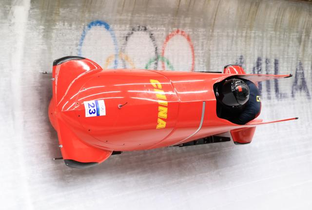 (260222) -- CORTINA D'AMPEZZO, Feb. 22, 2026 (Xinhua) -- Ying Qing/Wang Yu of China compete during the Bobsleigh 2-woman heat 3 at the 2026 Milan-Cortina Winter Olympics in Cortina, Italy, Feb. 21, 2026. (Xinhua/Ding Xu)