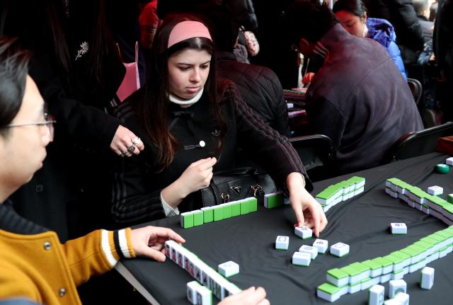 (260222) -- LONDON, Feb. 22, 2026 (Xinhua) -- People play Mahjong during a Chinese New Year celebration at Camden Market in London, Britain, Feb. 21, 2026. (Xinhua/Li Ying)