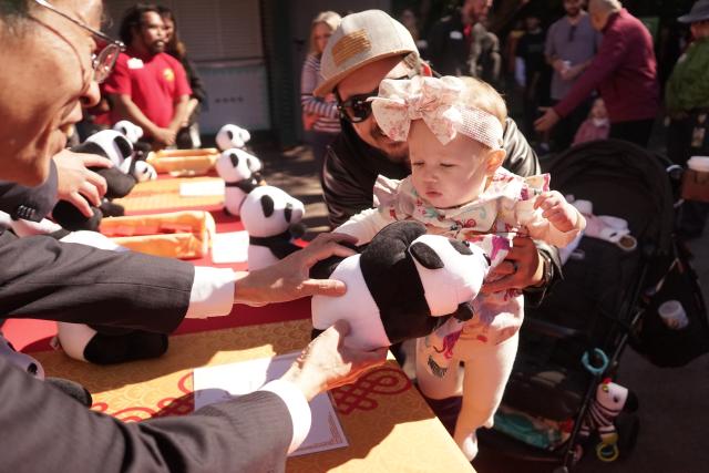 (260222) -- SAN DIEGO, Feb. 22, 2026 (Xinhua) -- A child receives a gift during a Chinese New Year celebration at San Diego Zoo in San Diego, California, the United States, on Feb. 21, 2026. The zoo began a two-day Chinese New Year celebration on Saturday. (Photo by Zeng Hui/Xinhua)