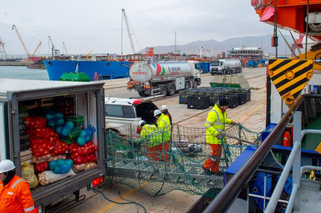 (260222) -- BAKU, Feb. 22, 2026 (Xinhua) -- Staff members transport food supplies onto a vessel at the Baku Shipyard in Baku, Azerbaijan, Feb. 10, 2026. TO GO WITH "Feature: 'Caspian' Spring Festival for Chinese oil explorers supporting Azerbaijan's energy exploration" (Xinhua/Chen Junfeng)