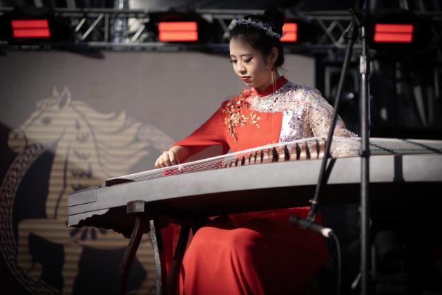 (260222) -- BUENOS AIRES, Feb. 22, 2026 (Xinhua) -- A woman performs traditional Chinese music during a Chinese New Year celebration event in La Plata, Buenos Aires, Argentina, Feb. 21, 2026. A series of activities to celebrate the Chinese New Year were held here on Saturday, attracting large numbers of local residents. (Photo by Martin Zabala/Xinhua)