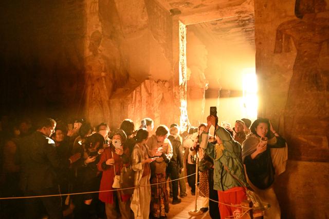(260222) -- ASWAN, Feb. 22, 2026 (Xinhua) -- Tourists visit the Great Temple of Abu Simbel during the Sun Festival in Aswan, Egypt, Feb. 22, 2026. During the Sun Festival, which falls on Feb. 22 and Oct. 22 every year, rays of the morning sun would reach the innermost shrine of the Great Temple of Abu Simbel and illuminate the inside sculptures. (Xinhua/Xin Mengchen)