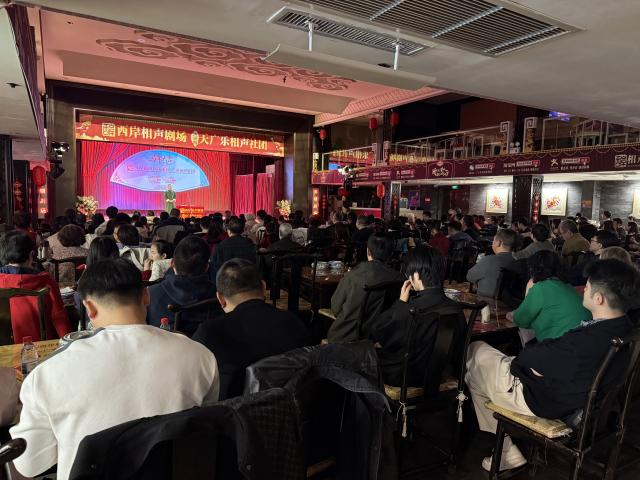 (260222) -- TIANJIN, Feb. 22, 2026 (Xinhua) -- People watch crosstalk, or Xiangsheng in Chinese, a popular Chinese comedic performance art, at a crosstalk teahouse in north China's Tianjin, Feb. 19, 2026. TO GO WITH "Economic Watch: Crosstalk teahouses enjoy rising popularity in China's Tianjin" (Xinhua)