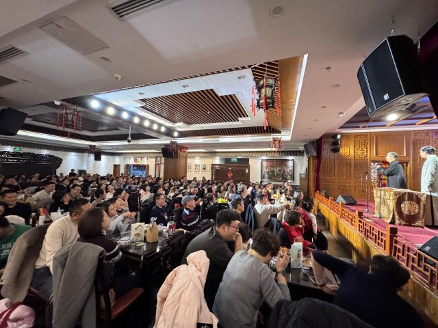 (260222) -- TIANJIN, Feb. 22, 2026 (Xinhua) -- People watch crosstalk, or Xiangsheng in Chinese, a popular Chinese comedic performance art, at a crosstalk teahouse in north China's Tianjin, Feb. 19, 2026. TO GO WITH "Economic Watch: Crosstalk teahouses enjoy rising popularity in China's Tianjin" (Xinhua)