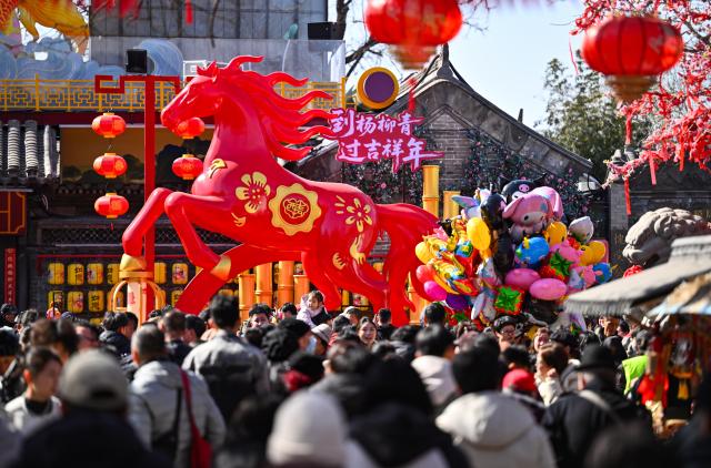 (260222) -- TIANJIN, Feb. 22, 2026 (Xinhua) -- Visitors have fun at Yangliuqing ancient town in Tianjin, north China, Feb. 22, 2026. Yangliuqing ancient town launched a range of activities featuring folk customs, traditional culture and interactive experiences, offering visitors an immersive folk feast during this Spring Festival holiday. (Xinhua/Zhao Zishuo)