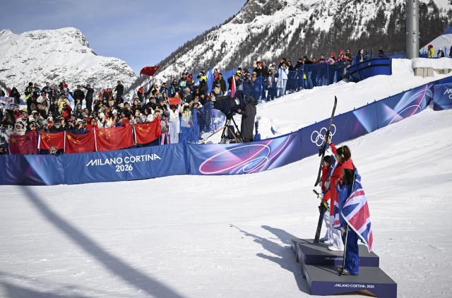 (260222) -- LIVIGNO, Feb. 22, 2026 (Xinhua) -- Silver medalist Li Fanghui (front L) of China, gold medalist Gu Ailing of China (front C) and bronze medalist Zoe Atkin of Britain pose after the awarding ceremony for freestyle skiing women's freeski halfpipe at the Milan-Cortina 2026 Olympic Winter Games in Livigno, Italy, Feb. 22, 2026. (Xinhua/Wu Huiwo)