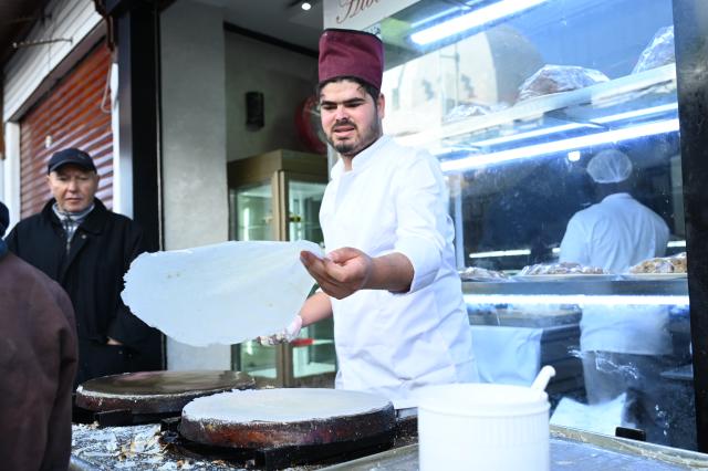 (260222) -- RABAT, Feb. 22, 2026 (Xinhua) -- A vendor makes traditional Moroccan pastries at a market during the Muslim holy month of Ramadan in Rabat, Morocco, on Feb. 21, 2026. (Photo by Aissa/Xinhua)