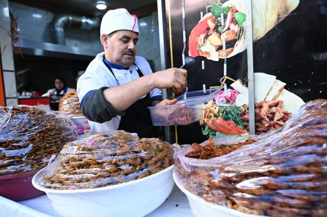 (260222) -- RABAT, Feb. 22, 2026 (Xinhua) -- A vendor sells traditional Moroccan pastries at a market during the Muslim holy month of Ramadan in Rabat, Morocco, on Feb. 21, 2026. (Photo by Aissa/Xinhua)