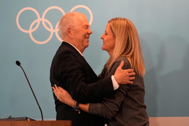 (260222) -- MILAN, Feb. 22, 2026 (Xinhua) -- IOC President Kirsty Coventry (R) embraces Olle Dahlin, President of the International Biathlon Union, during an IOC session at the Milan-Cortina 2026 Olympic Winter Games in Milan, Italy, Feb. 22, 2026. (Luca Bruno/Pool via Xinhua)