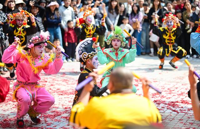 (260222) -- PUNING, Feb. 22, 2026 (Xinhua) -- Artists perform Yingge dance in Puning, south China's Guangdong Province, Feb. 22, 2026. The Yingge dance, or "dance to the hero's song," is a folk dance of south China's Guangdong Province which has enjoyed growing popularity nationwide in recent years. As many shops in Puning chose to open their doors to start the new year's business on Sunday, the sixth day of the Chinese New Year, Yingge dance teams staged wonderful performances across the city to convey their best wishes for a prosperous start of the new year. (Xinhua/Chen Yehua)