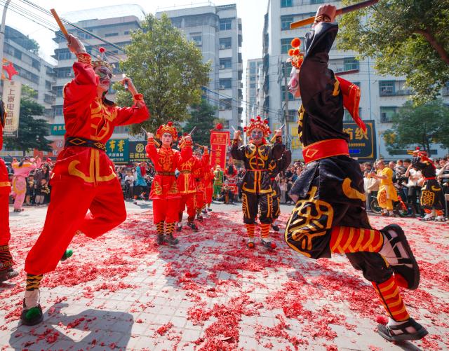 (260222) -- PUNING, Feb. 22, 2026 (Xinhua) -- Artists perform Yingge dance in Puning, south China's Guangdong Province, Feb. 22, 2026. The Yingge dance, or "dance to the hero's song," is a folk dance of south China's Guangdong Province which has enjoyed growing popularity nationwide in recent years. As many shops in Puning chose to open their doors to start the new year's business on Sunday, the sixth day of the Chinese New Year, Yingge dance teams staged wonderful performances across the city to convey their best wishes for a prosperous start of the new year. (Xinhua/Chen Yehua)