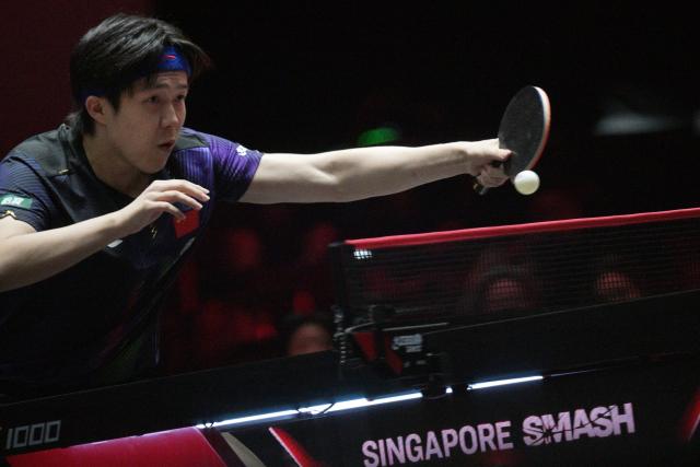 (260222) -- SINGAPORE, Feb. 22, 2026 (Xinhua) -- Wang Chuqin hits a return during the men's singles round of 64 match between Wang Chuqin of China and Finn Luu of Australia at the World Table Tennis (WTT) Singapore Smash 2026 in Singapore on Feb. 22, 2026. (Photo by Then Chih Wey/Xinhua)