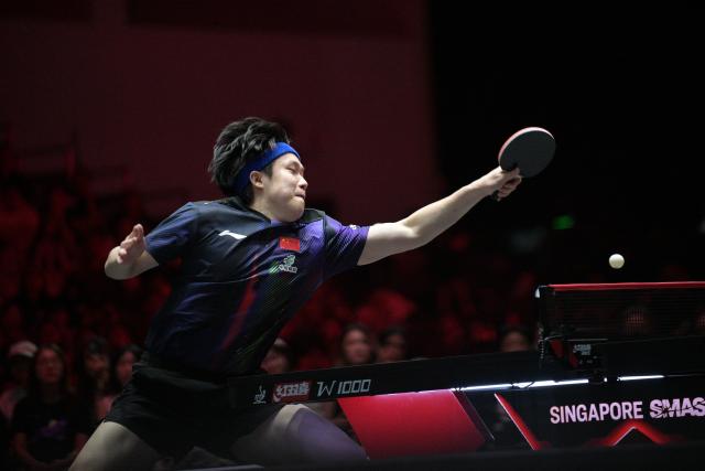 (260222) -- SINGAPORE, Feb. 22, 2026 (Xinhua) -- Wang Chuqin hits a return during the men's singles round of 64 match between Wang Chuqin of China and Finn Luu of Australia at the World Table Tennis (WTT) Singapore Smash 2026 in Singapore on Feb. 22, 2026. (Photo by Then Chih Wey/Xinhua)