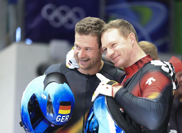 (260222) -- CORTINA D'AMPEZZO, Feb. 22, 2026 (Xinhua) -- Johannes Lochner (L) and Francesco Friedrich of Germany celebrate after the Bobsleigh 4-man heat 4 at the 2026 Milan-Cortina Winter Olympics in Cortina D'Ampezzo, Italy, Feb. 22, 2026. (Xinhua/Ding Xu)