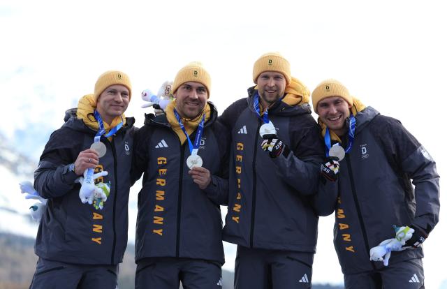 (260222) -- CORTINA D'AMPEZZO, Feb. 22, 2026 (Xinhua) -- Silver medalists Francesco Friedrich/Matthias Sommer/Alexander Schuller/Felix Straub of Germany (L to R) pose during the awarding ceremony for Bobsleigh 4-man at the 2026 Milan-Cortina Winter Olympics in Cortina D'Ampezzo, Italy, Feb. 22, 2026. (Xinhua/Ding Xu)