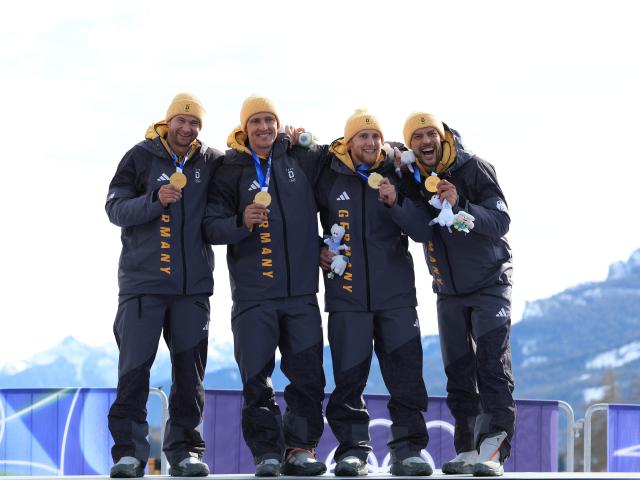 (260222) -- CORTINA D'AMPEZZO, Feb. 22, 2026 (Xinhua) -- Gold medalists Johannes Lochner/Thorsten Margis/Jorn Wenzel/Georg Fleischhauer of Germany (L to R) pose during the awarding ceremony for Bobsleigh 4-man at the 2026 Milan-Cortina Winter Olympics in Cortina D'Ampezzo, Italy, Feb. 22, 2026. (Xinhua/Ding Xu)