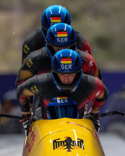 (260222) -- CORTINA D'AMPEZZO, Feb. 22, 2026 (Xinhua) -- Johannes Lochner/Thorsten Margis/Jorn Wenzel/Georg Fleischhauer of Germany compete during the Bobsleigh 4-man heat 3 at the 2026 Milan-Cortina Winter Olympics in Cortina D'Ampezzo, Italy, Feb. 22, 2026. (Xinhua/Fei Maohua)