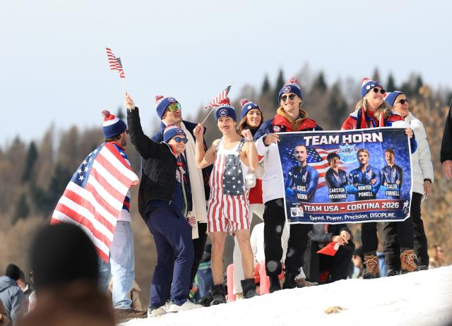 (260222) -- CORTINA D'AMPEZZO, Feb. 22, 2026 (Xinhua) -- Spectators cheer for athletes before the Bobsleigh 4-man heat 3 at the 2026 Milan-Cortina Winter Olympics in Cortina D'Ampezzo, Italy, Feb. 22, 2026. (Xinhua/Ding Xu)