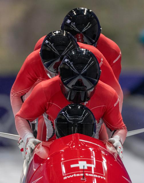 (260222) -- CORTINA D'AMPEZZO, Feb. 22, 2026 (Xinhua) -- Michael Vogt/Andreas Haas/Amadou David Ndiaye/Mario Aeberhard of Switzerland compete during the Bobsleigh 4-man heat 3 at the 2026 Milan-Cortina Winter Olympics in Cortina D'Ampezzo, Italy, Feb. 22, 2026. (Xinhua/Fei Maohua)