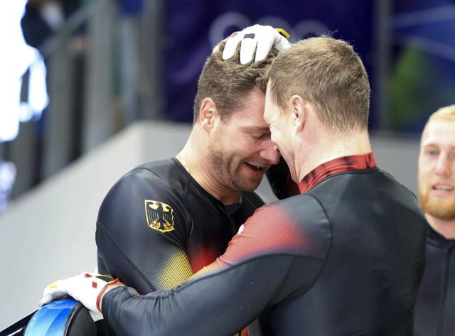 (260222) -- CORTINA D'AMPEZZO, Feb. 22, 2026 (Xinhua) -- Johannes Lochner (L) and Francesco Friedrich of Germany celebrate after the Bobsleigh 4-man heat 4 at the 2026 Milan-Cortina Winter Olympics in Cortina D'Ampezzo, Italy, Feb. 22, 2026. (Xinhua/Ding Xu)