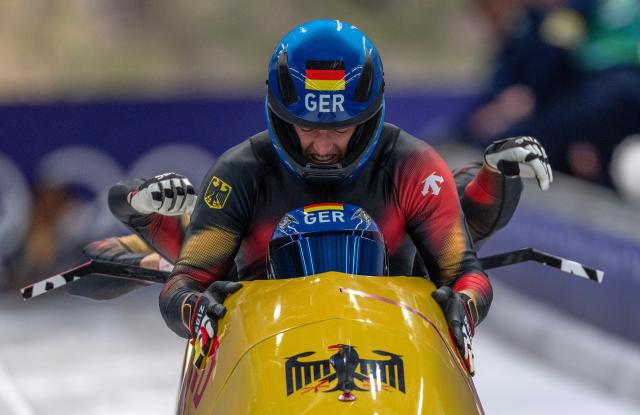 (260222) -- CORTINA D'AMPEZZO, Feb. 22, 2026 (Xinhua) -- Johannes Lochner/Thorsten Margis/Jorn Wenzel/Georg Fleischhauer of Germany compete during the Bobsleigh 4-man heat 3 at the 2026 Milan-Cortina Winter Olympics in Cortina D'Ampezzo, Italy, Feb. 22, 2026. (Xinhua/Fei Maohua)