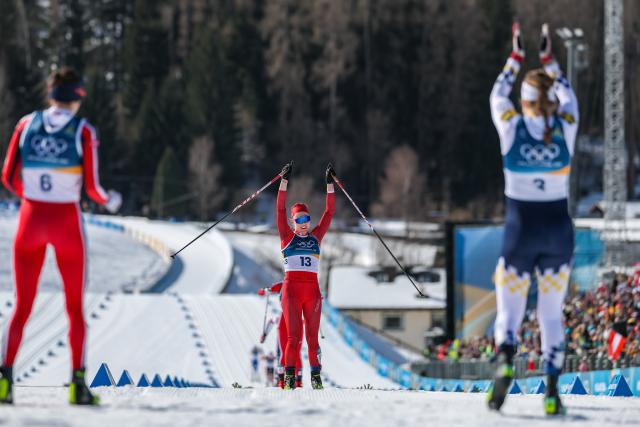 (260222) -- TESERO, Feb. 22, 2026 (Xinhua) -- Nadja Kaelin (C) of Switzerland celebrates after finishing the cross-country skiing women's 50km mass start classic match at the Milan-Cortina 2026 Olympic Winter Games in Tesero, Italy, Feb. 22, 2026. (Xinhua/Huang Wei)