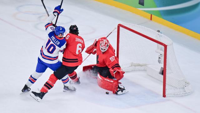 (260222) -- MILAN, Feb. 22, 2026 (Xinhua) -- JT Miller (L) of the United States competes during the ice hockey men's gold medal game between Canada and the United States at the Milan-Cortina 2026 Olympic Winter Games in Milan, Italy, Feb. 22, 2026. (Xinhua/Tao Xiyi)