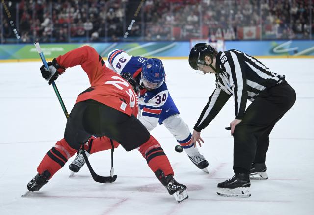 (260222) -- MILAN, Feb. 22, 2026 (Xinhua) -- Auston Matthews of the United States vies with Nathan Mackinnon of Canada during the ice hockey men's gold medal game between Canada and the United States at the Milan-Cortina 2026 Olympic Winter Games in Milan, Italy, Feb. 22, 2026. (Xinhua/Zhang Haofu)