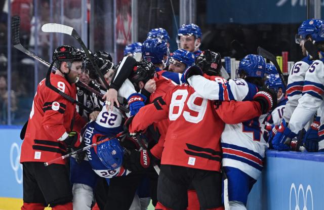 (260222) -- MILAN, Feb. 22, 2026 (Xinhua) -- Players fight during the ice hockey men's gold medal game between Canada and the United States at the Milan-Cortina 2026 Olympic Winter Games in Milan, Italy, Feb. 22, 2026. (Xinhua/Zhang Haofu)