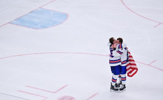 (260222) -- MILAN, Feb. 22, 2026 (Xinhua) -- Charlie McAvoy of the United States (L) hugs teammate Jack Eichel after the ice hockey men's gold medal game between Canada and the United States at the Milan-Cortina 2026 Olympic Winter Games in Milan, Italy, Feb. 22, 2026. (Xinhua/Tao Xiyi)