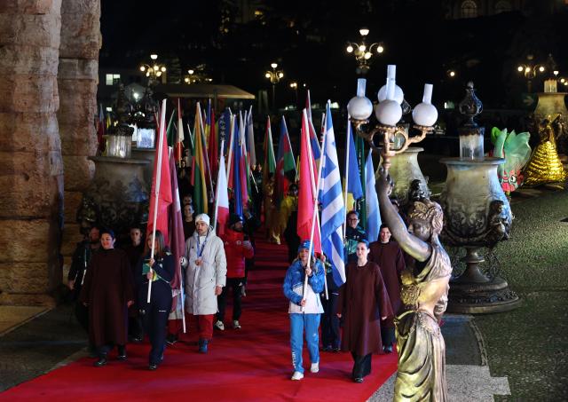 (260222) -- VERONA, Feb. 22, 2026 (Xinhua) -- Flagbearers parade into the venue during the closing ceremony of the Milan-Cortina 2026 Olympic Winter Games at Verona Olympic Arena in Verona, Italy, Feb. 22, 2026. (Xinhua/Wang Kaiyan)