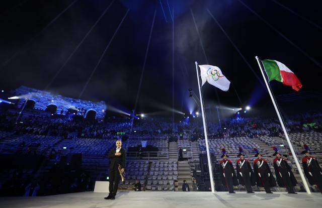(260222) -- VERONA, Feb. 22, 2026 (Xinhua) -- This photo taken on Feb. 22, 2026 shows the Olympic flag and the Italian national flag during the closing ceremony of the Milan-Cortina 2026 Olympic Winter Games at Verona Olympic Arena in Verona, Italy. (Xinhua/Li Ming)