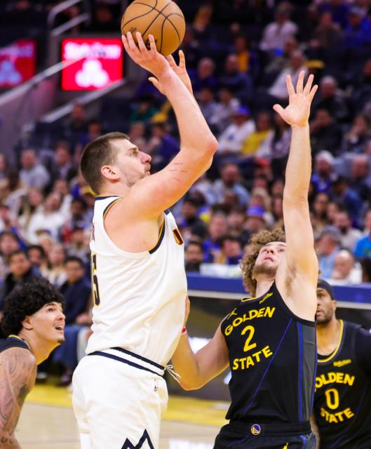 (260223) -- SAN FRANCISCO, Feb. 23, 2026 (Xinhua) -- Nikola Jokic (L) of Denver Nuggets shoots during the 2025-2026 NBA regular season game between Golden State Warriors and Denver Nuggets in San Francisco, the United States, Feb. 22, 2026. (Photo by Arthur Dong/Xinhua)