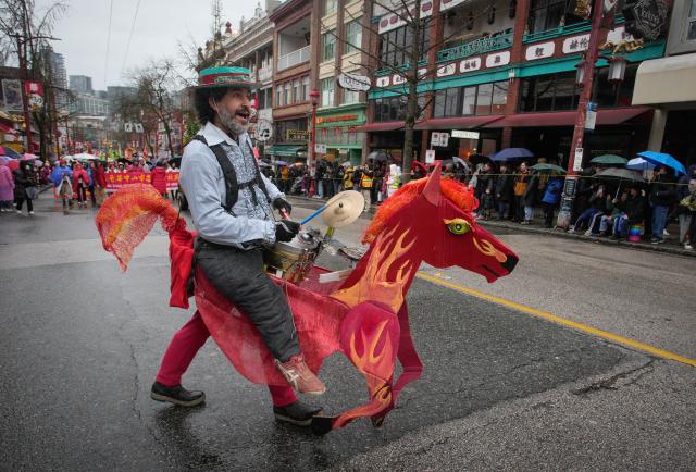 (260223) -- VANCOUVER, Feb. 23, 2026 (Xinhua) -- A musician in a horse-shaped costume performs during a Spring Festival parade at Chinatown in Vancouver, British Columbia, Canada, on Feb. 22, 2026. The 52nd annual Vancouver Chinatown Spring Festival Parade was held here on Sunday to celebrate the Chinese Year of the Horse. (Photo by Liang Sen/ Xinhua)