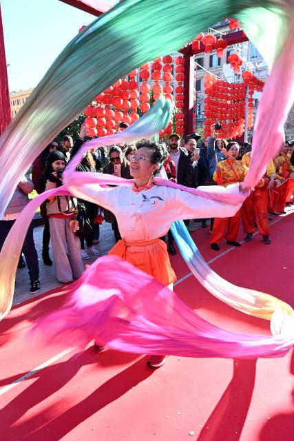(260223) -- ROME, Feb. 23, 2026 (Xinhua) -- A woman performs during a Chinese New Year parade in Rome, Italy, Feb. 22, 2026. (Photo by Elisa Lingria/Xinhua)