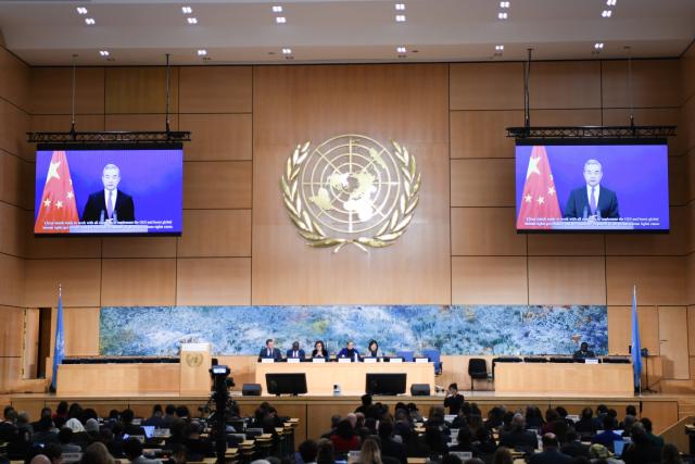 (260223) -- GENEVA, Feb. 23, 2026 (Xinhua) -- This photo taken on Feb. 23, 2026 shows Chinese Foreign Minister Wang Yi, also a member of the Political Bureau of the Communist Party of China Central Committee, giving a speech via video link at the high-level segment of the 61st session of the United Nations Human Rights Council in Geneva, Switzerland. (Xinhua/Lian Yi)