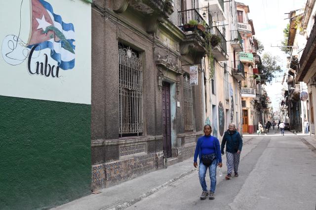 (260223) -- HAVANA, Feb. 23, 2026 (Xinhua) -- Photo taken on Feb. 23, 2026 shows people walking along a street in Havana, capital of Cuba. (Photo by Joaquin Hernandez/Xinhua)