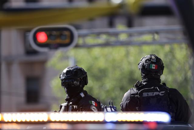 (260223) -- MEXICO CITY, Feb. 23, 2026 (Xinhua) -- Security personnel guard on a street in Mexico City, Mexico, Feb. 23, 2026. Retaliation attacks from the Jalisco New Generation Cartel have left 27 security personnel dead, Mexico's Secretary of Security and Citizen Protection Omar Garcia Harfuch said Monday at a press conference. Mexican military forces launched an operation on Sunday and killed the Jalisco New Generation Cartel leader Nemesio Oseguera Cervantes, alias "El Mencho." Members of cartels have set fire to cars and commercial facilities, and blocked roads. Some states closed schools on Monday. (Photo by Francisco Canedo/Xinhua)