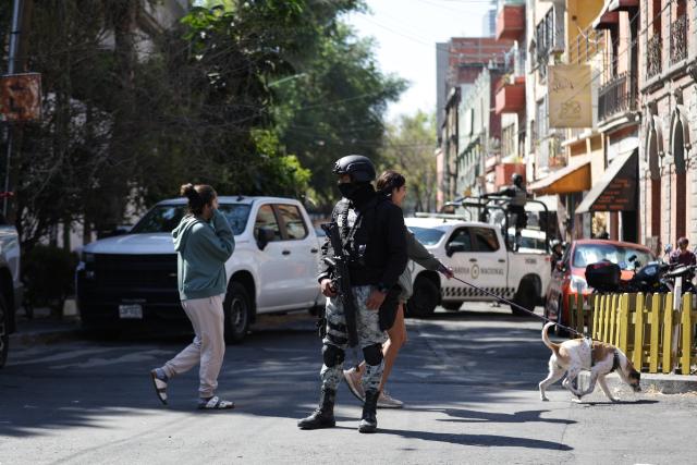 (260223) -- MEXICO CITY, Feb. 23, 2026 (Xinhua) -- Security personnel guard on a street in Mexico City, Mexico, Feb. 23, 2026. Retaliation attacks from the Jalisco New Generation Cartel have left 27 security personnel dead, Mexico's Secretary of Security and Citizen Protection Omar Garcia Harfuch said Monday at a press conference. Mexican military forces launched an operation on Sunday and killed the Jalisco New Generation Cartel leader Nemesio Oseguera Cervantes, alias "El Mencho." Members of cartels have set fire to cars and commercial facilities, and blocked roads. Some states closed schools on Monday. (Photo by Francisco Canedo/Xinhua)