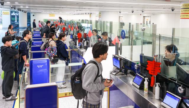 (260224) -- HAIKOU, Feb. 24, 2026 (Xinhua) -- Passengers go through border inspection procedures at Haikou Meilan International Airport in Haikou, south China's Hainan Province, Feb. 16, 2026. According to Haikou General Station of Immigration Inspection, Hainan border inspection authorities handled over 86,000 entries and exits during this Spring Festival holiday as of Feb. 23, an increase of 43.3 percent compared to the last year. (Photo by Sun Haorong/Xinhua)