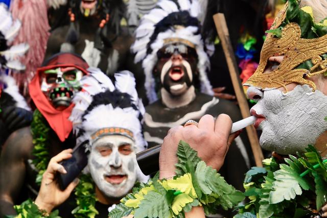 (260224) -- BEIJING, Feb. 24, 2026 (Xinhua) -- Participants are pictured during the traditional "Zambo" parade in Tripoli, northern Lebanon, on Feb. 22, 2026. People painted their bodies black, wore feathers, torn clothing, and masks, and marched through the streets in groups carrying swords and daggers, beating drums, and singing old songs on the last Sunday before the fasting season begins. (Photo by Ali Hashisho/Xinhua)