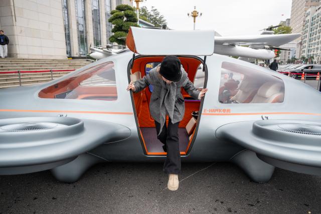 (260224) -- WUHAN, Feb. 24, 2026 (Xinhua) -- A visitor exits an electric vertical takeoff and landing (eVTOL) aircraft cabin in Wuhan, central China's Hubei Province, Feb. 24, 2026. A variety of electric vertical takeoff and landing (eVTOL) aircraft and humanoid robots made their debut at an event in Wuhan, showcasing the province's latest achievements of industries such as low-altitude economy and artificial intelligence. (Xinhua/Xiao Yijiu)