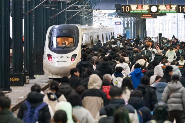 (260224) -- BEIJING, Feb. 24, 2026 (Xinhua) -- Passengers are seen on a platform at Harbin Railway Station in Harbin, northeast China's Heilongjiang Province, Feb. 22, 2026. China's railways handled 121 million passenger trips during the just-concluded Spring Festival holiday, up 11.5 percent compared with last year's holiday period, official data showed on Tuesday. (Photo by Yuan Yong/Xinhua)