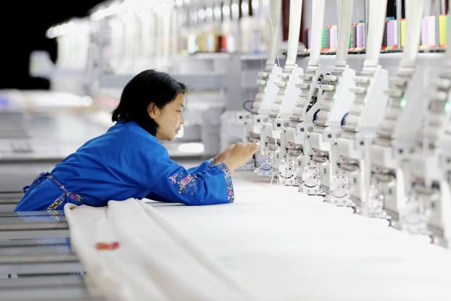 (260224) -- BEIJING, Feb. 24, 2026 (Xinhua) -- A worker works at a Miao embroidery workshop in Qiandongnan Miao and Dong Autonomous Prefecture, southwest China's Guizhou Province, Feb. 24, 2026. Factories and companies across China resumed work after the Spring Festival holiday on Tuesday. (Photo by Tai Shengzhi/Xinhua)