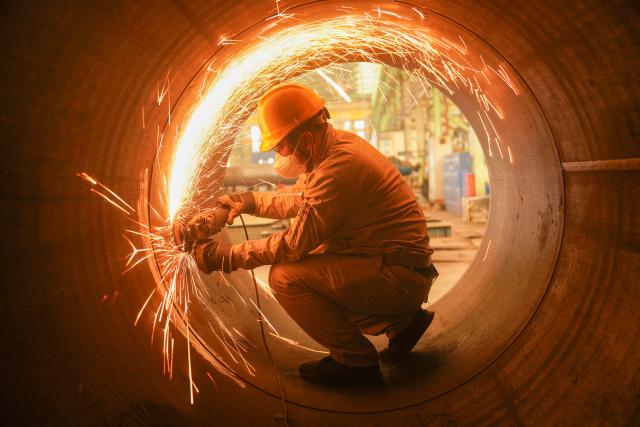 (260224) -- BEIJING, Feb. 24, 2026 (Xinhua) -- A worker works in the workshop of a steel structure company in Meishan, southwest China's Sichuan Province, Feb. 24, 2026. Factories and companies across China resumed work after the Spring Festival holiday on Tuesday. (Photo by Weng Guangjian/Xinhua)
