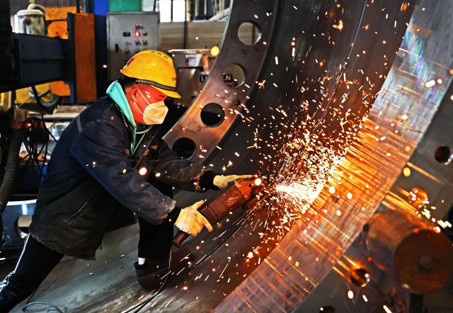 (260224) -- BEIJING, Feb. 24, 2026 (Xinhua) -- A worker works at the workshop of a wind power equipment company in an economic and technological development zone in Lianyungang, east China's Jiangsu Province, Feb. 24, 2026. Factories and companies across China resumed work after the Spring Festival holiday on Tuesday. (Photo by Wang Jianmin/Xinhua)